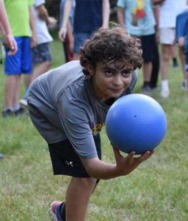 boy rolling ball in game