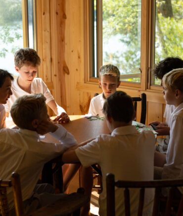 campers inside of cabin at table